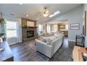 Open concept living room with hardwood floors and a view into the kitchen area at 11560 Cherry Blossom West Dr, Fishers, IN 46038