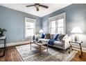 Light and airy living room with hardwood floors and a comfy sofa at 232 W Wiley St, Greenwood, IN 46142