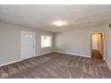 Living room featuring neutral walls, carpeting, and an archway at 3060 S Shortridge Rd, Indianapolis, IN 46239