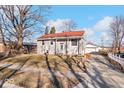 Ranch home with red roof, covered porch, and landscaped yard at 807 Alden Dr, Fortville, IN 46040