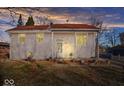 House exterior at dusk with lights on, showcasing curb appeal at 807 Alden Dr, Fortville, IN 46040