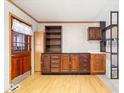 Dark wood cabinets, built-in shelving, and light flooring at 807 Alden Dr, Fortville, IN 46040