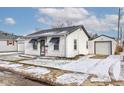 White bungalow with black accents, snow-covered yard, and garage at 917 Garfield St, Lebanon, IN 46052