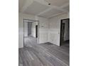 Living room with new gray flooring and drywall at 1207 W 35Th St, Indianapolis, IN 46208