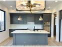 Modern kitchen with dark gray cabinetry, quartz countertops and a large island at 1678 Ties Way, Westfield, IN 46074