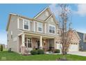 Two-story home with gray siding, brick accents, and a covered porch at 2707 Southward Dr, Greenwood, IN 46143