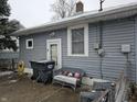 Small patio with trash cans and seating at 2814 Brown St, Anderson, IN 46016