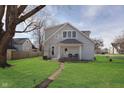 Back view of a house with a small covered porch, path, and landscape lighting at 330 S Woodward St, Lapel, IN 46051