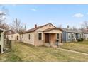 Cute bungalow style home with a freshly painted exterior and stone foundation at 3709 Fletcher Ave, Indianapolis, IN 46203