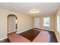 Bright living room with hardwood floors and an arched doorway leading to other rooms at 3709 Fletcher Ave, Indianapolis, IN 46203