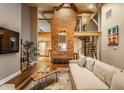 Spacious living area with exposed brick and spiral staircase at 714 Buchanan St # 16, Indianapolis, IN 46203