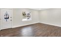 Empty living room with hardwood floors and white walls at 8327 Crousore Rd, Indianapolis, IN 46219