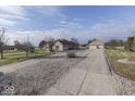 House with a long driveway leading to a detached garage at 9048 N Watson Meadows Ln, Mooresville, IN 46158