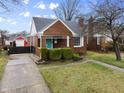 Attractive brick home with a neat lawn and a paved driveway at 1246 N Downey Ave, Indianapolis, IN 46219