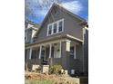 Gray two-story house with a front porch and brick base at 1715 Union St, Indianapolis, IN 46225