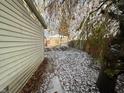 Backyard view with a detached garage, wooden fence, and light snow cover at 1827 Mansfield St, Indianapolis, IN 46202