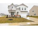 Two-story house with gray and white siding, a large driveway, and landscaping at 2546 Mounts Run Ln, Whitestown, IN 46075