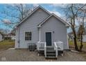 Back exterior of the home with a gravel driveway and an AC unit at 2709 Station St, Indianapolis, IN 46218