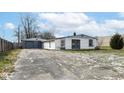 White ranch house with gray doors and detached garage at 4925 W Raymond St, Indianapolis, IN 46241