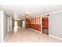 Spacious living room with wood-paneled accent wall and ceiling fan at 4925 W Raymond St, Indianapolis, IN 46241