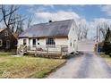 House exterior with a detached garage and front yard at 6348 Kingsley Dr, Indianapolis, IN 46220