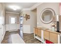 Entryway with wood-look floors, white wainscoting, and a large mirror at 8885 River Ridge Dr, Brownsburg, IN 46112