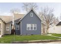 Rear view of a gray house with white trim and a grassy yard at 209 Trowbridge St, Indianapolis, IN 46201