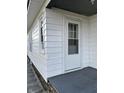 Close-up of the back door entrance with a small porch and white siding at 1008 W 2Nd St, Anderson, IN 46016