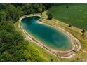 An aerial view showcasing a tranquil pond with a gazebo at 4832 E 200 N, Anderson, IN 46012