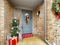 Festive front door with holiday decorations, presents, and a small Christmas tree at 1242 Bitterwood Ct, Columbus, IN 47201