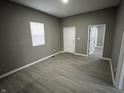 Bedroom with gray walls, wood-look flooring, and ample natural light at 416 N Mulberry St, Muncie, IN 47305