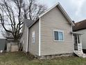 Side view of a two-story home with updated siding at 416 N Mulberry St, Muncie, IN 47305