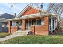 Close-up of a charming brick and siding duplex with a covered porch at 620 N Rural St, Indianapolis, IN 46201