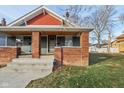 Close-up view of the duplex's front porch and brick facade at 620 N Rural St, Indianapolis, IN 46201
