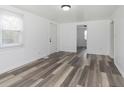 Bright, open living room with new wood-look flooring and fresh white paint at 728 S Worth Ave, Indianapolis, IN 46241