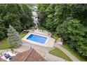 Elevated view showcasing pool, home, and wooded surroundings at 7701 Center Lake Rd, Nineveh, IN 46164