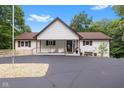 Charming home with covered porch, paved driveway, and landscaped front yard at 7701 Center Lake Rd, Nineveh, IN 46164