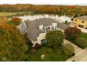 Luxury home with lake views and spacious grounds in autumn at 8804 Waterside Dr, Indianapolis, IN 46278