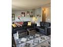 Living room with black leather couches and patterned rug at 105 S Church St, Martinsville, IN 46151