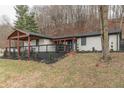 White brick home with black trim and a wood-covered porch, nestled on a grassy hillside at 1749 N Blue Bluff Rd, Martinsville, IN 46151