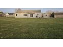 Backyard with a large grassy area and a small patio at 2039 Round Barn Ct, Anderson, IN 46017