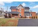 Red brick home with a large backyard and parking area at 321 N State St, Greenfield, IN 46140