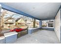 Covered front porch with brick accents, offering a view of the neighborhood at 3458 N Kenwood Ave, Indianapolis, IN 46208