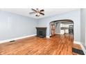 Living room with hardwood floors, a black brick fireplace, and an open archway to the kitchen at 3458 N Kenwood Ave, Indianapolis, IN 46208