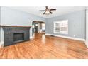 Living area with hardwood floors, a black fireplace, and large windows providing ample natural light at 3458 N Kenwood Ave, Indianapolis, IN 46208