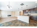 Open concept kitchen with island, stainless steel appliances, and dark brown cabinets at 610 Atlas Dr, Lebanon, IN 46052