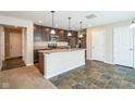 Modern kitchen with island, stainless steel appliances, and dark brown cabinets at 610 Atlas Dr, Lebanon, IN 46052