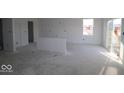 Unfinished kitchen space with white walls and a partial wall defining the kitchen area at 6114 Paperbark Way, Indianapolis, IN 46259