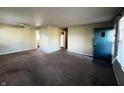 Open living room with carpeted floors, a ceiling fan, and access to another room at 7835 E 50Th St, Indianapolis, IN 46226