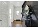 Bright entryway with hardwood floors, a statement wall, and a modern console table at 19728 Patcham Rd, Westfield, IN 46074